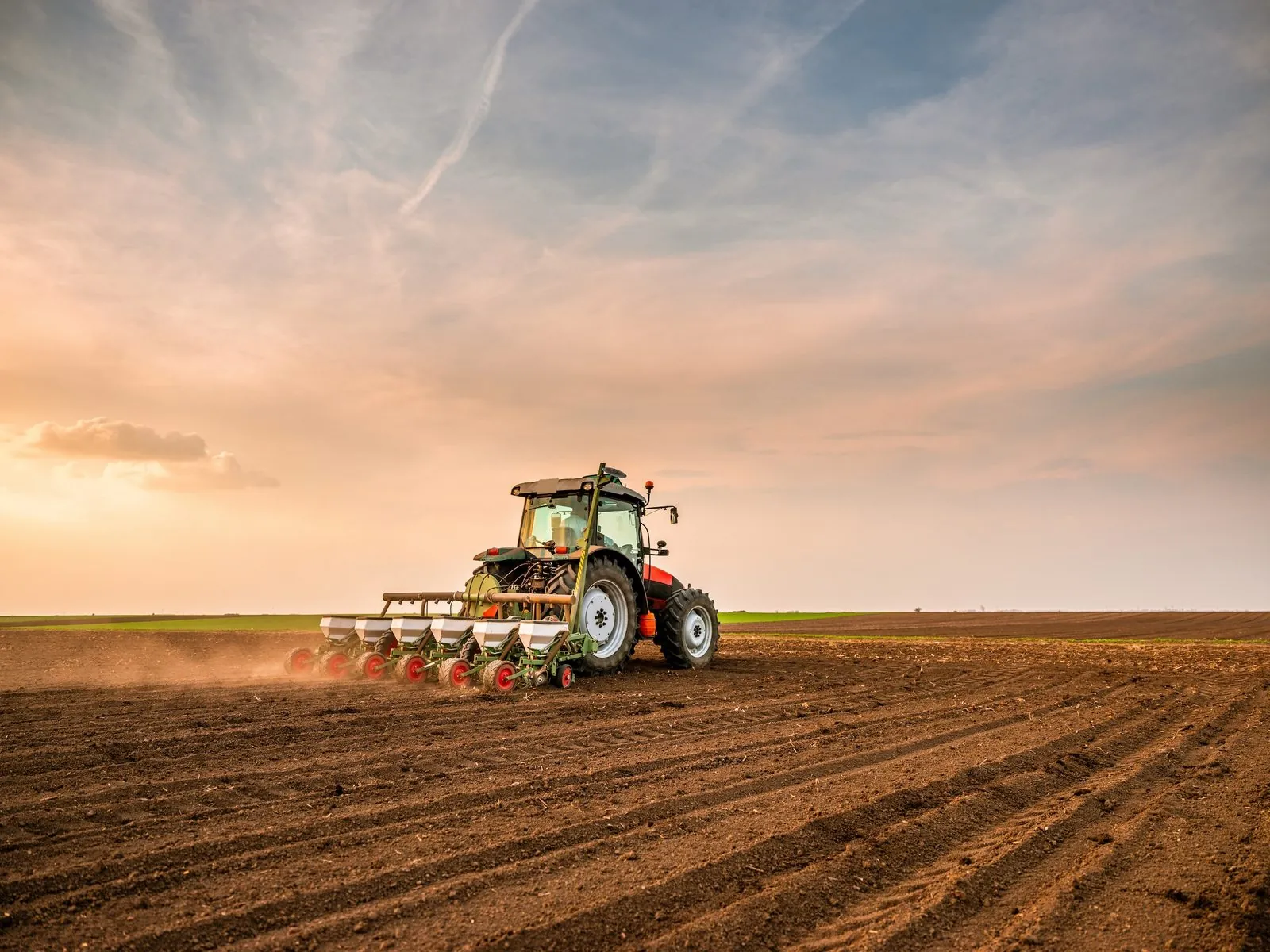 Agricultural equipment in operation showing custom-machined components in field applications