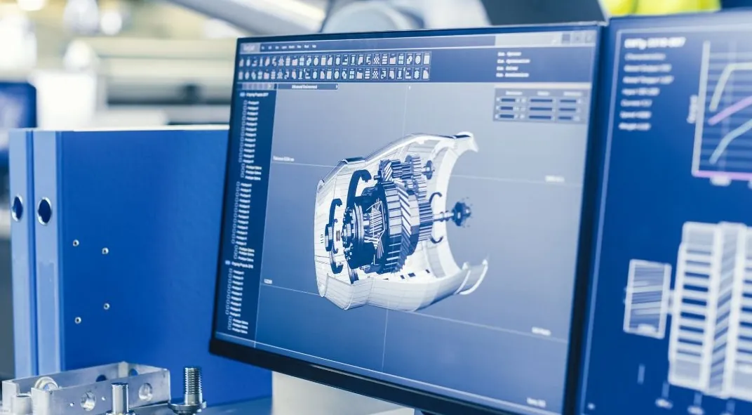 Engineering workstation displaying detailed 3D CAD model of a complex mechanical assembly next to a precision-machined component
